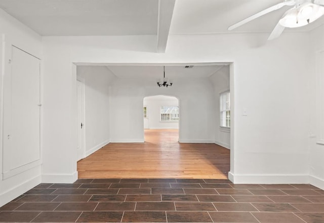 905 NE 21st St, Oklahoma City, OK 73105 - unfurnished room featuring wood finished floors, arched walkways, ceiling fan, and baseboards