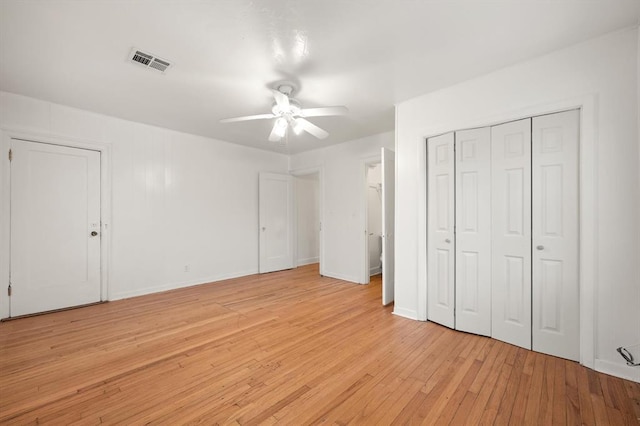 905 NE 21st St, Oklahoma City, OK 73105 - unfurnished bedroom with light wood-style floors, a closet, baseboards, and a ceiling fan