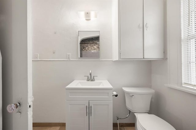 905 NE 21st St, Oklahoma City, OK 73105 - bathroom featuring toilet, vanity, and baseboards