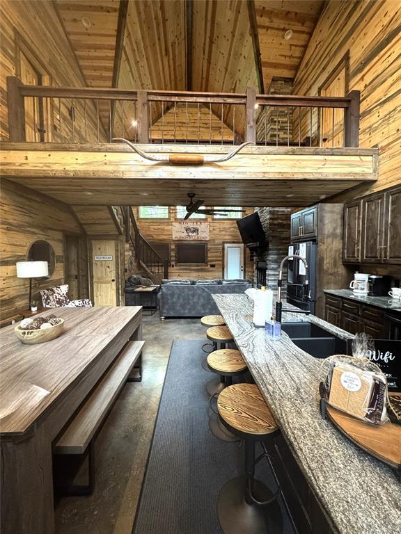 161 Champion Way, Broken Bow, OK 74728 - dining area with wood walls, wooden ceiling, and stairway