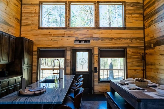161 Champion Way, Broken Bow, OK 74728 - dining space featuring wooden walls and a towering ceiling