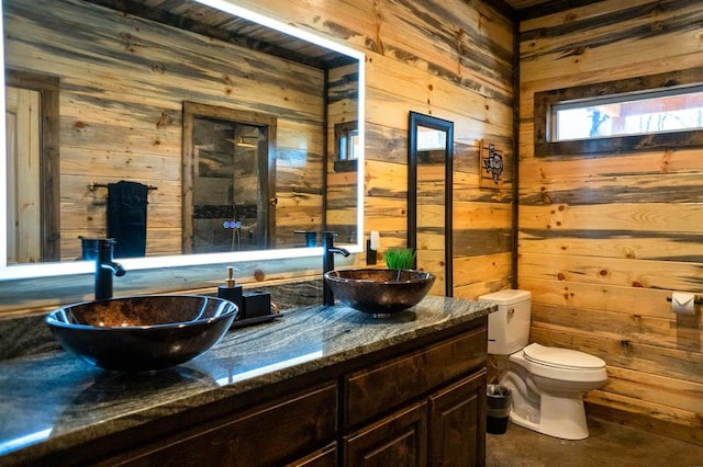 161 Champion Way, Broken Bow, OK 74728 - bathroom featuring wood walls, double vanity, and toilet
