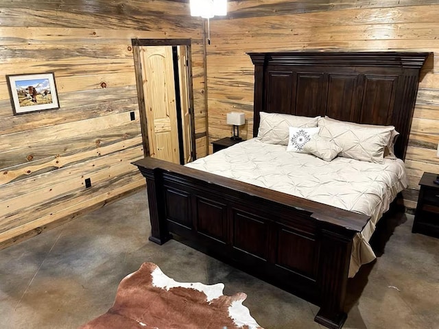 161 Champion Way, Broken Bow, OK 74728 - bedroom featuring wood walls and concrete floors