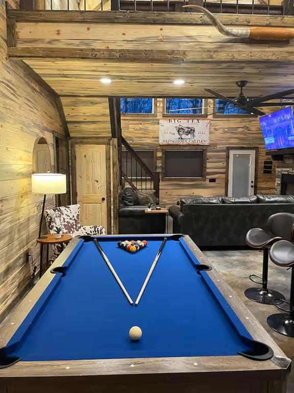 161 Champion Way, Broken Bow, OK 74728 - rec room featuring wood walls, ceiling fan, and lofted ceiling