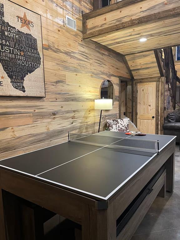 161 Champion Way, Broken Bow, OK 74728 - rec room featuring wooden walls and lofted ceiling
