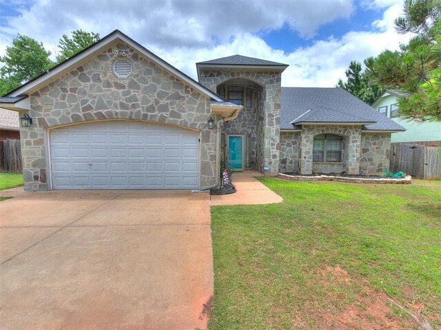 17612 Durbin Park Rd, Edmond, OK 73012 - view of front of house with stone siding, driveway, a garage, and a shingled roof
