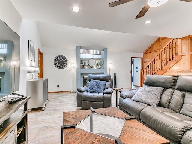 17612 Durbin Park Rd, Edmond, OK 73012 - living area featuring vaulted ceiling, stairs, ceiling fan, a fireplace, and light wood-type flooring