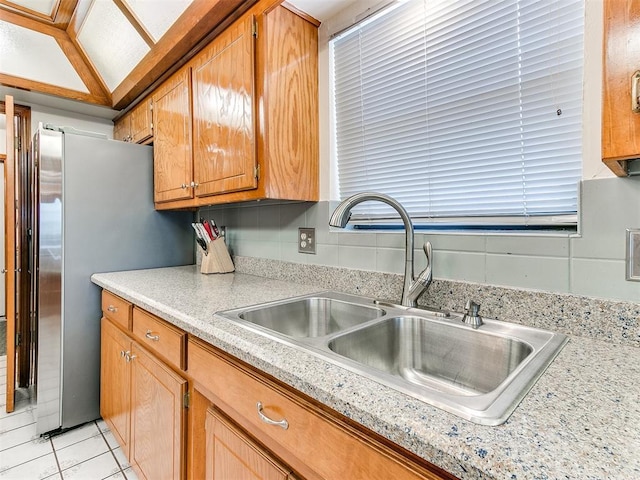 17612 Durbin Park Rd, Edmond, OK 73012 - kitchen featuring a sink, light countertops, freestanding refrigerator, and brown cabinets