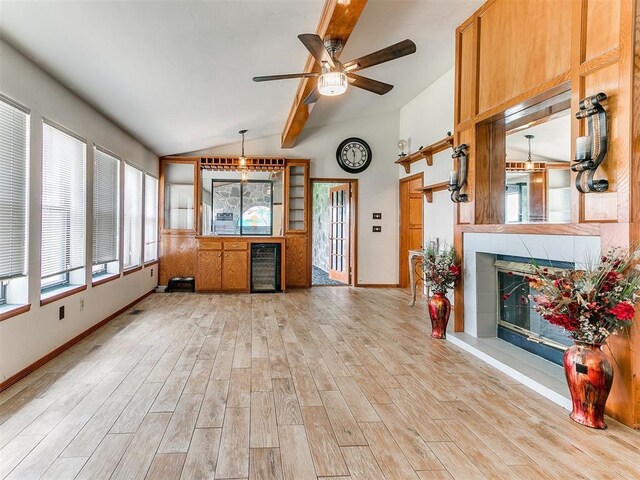 17612 Durbin Park Rd, Edmond, OK 73012 - unfurnished living room featuring light wood-style flooring, a tile fireplace, a ceiling fan, baseboards, and beverage cooler