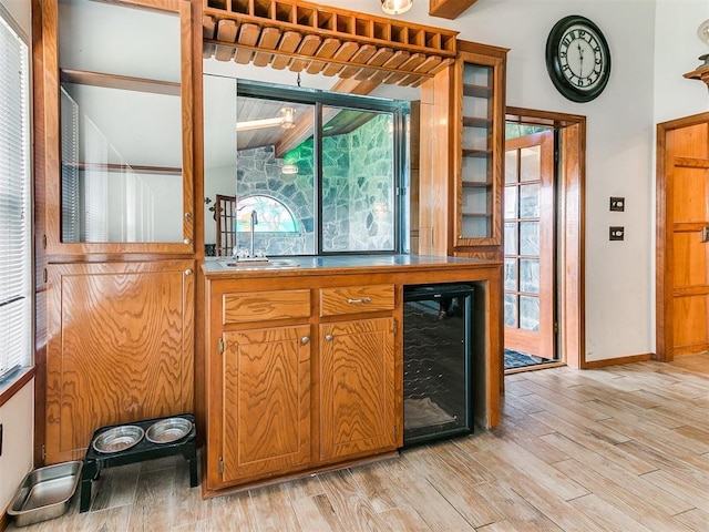 17612 Durbin Park Rd, Edmond, OK 73012 - bar featuring wine cooler, a sink, light wood-style flooring, and baseboards