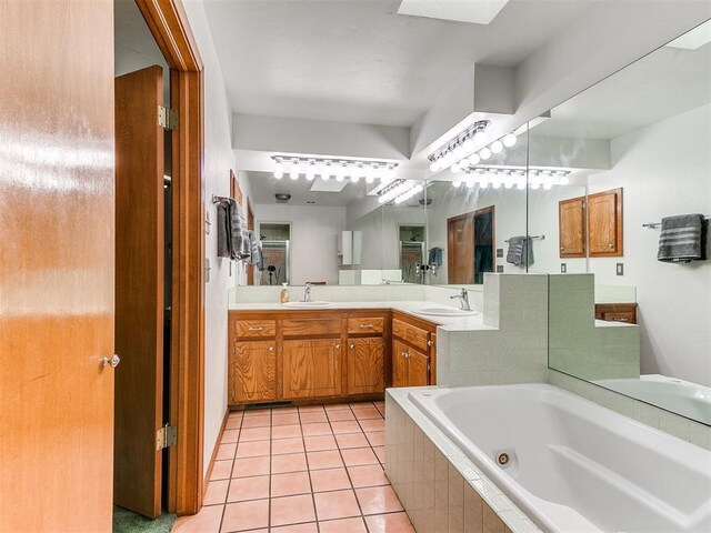 17612 Durbin Park Rd, Edmond, OK 73012 - bathroom with a tub with jets, tile patterned floors, and vanity