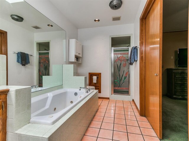 17612 Durbin Park Rd, Edmond, OK 73012 - bathroom featuring a tub with jets, tile patterned flooring, and a closet