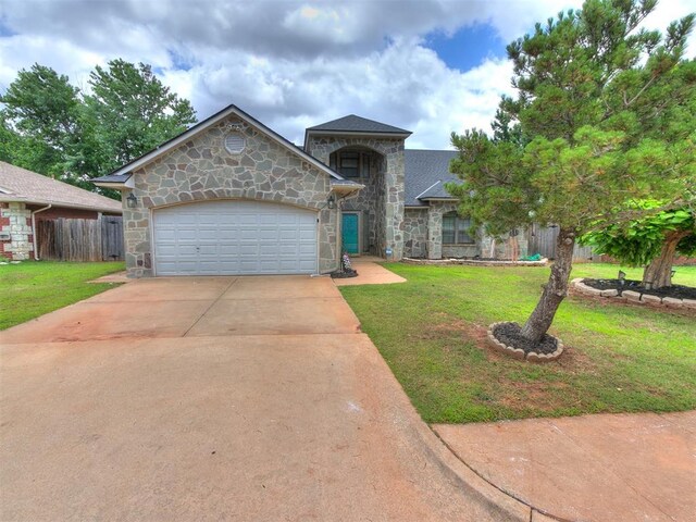 17612 Durbin Park Rd, Edmond, OK 73012 - view of front facade featuring stone siding, concrete driveway, a garage, and a shingled roof