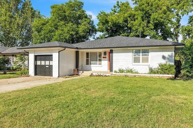 5712 N Roff Ave, Oklahoma City, OK 73112 - view of front of property with a garage, a front lawn, brick siding, concrete driveway, and roof with shingles