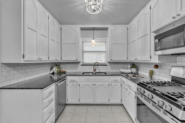 5712 N Roff Ave, Oklahoma City, OK 73112 - kitchen with appliances with stainless steel finishes, a sink, white cabinets, and light marble finish flooring