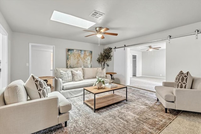 5712 N Roff Ave, Oklahoma City, OK 73112 - living area with a barn door, carpet, ceiling fan, and a skylight