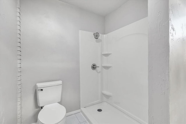5712 N Roff Ave, Oklahoma City, OK 73112 - bathroom with toilet, a shower, marble finish floors, and baseboards