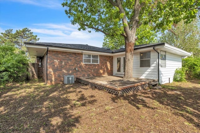 5712 N Roff Ave, Oklahoma City, OK 73112 - back of house featuring a deck, brick siding, french doors, and central AC unit