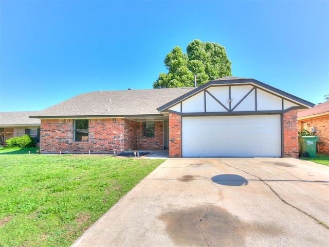1033 Linn Ln, Yukon, OK 73099 - view of front of home with brick siding, a garage, a front yard, driveway, and a shingled roof