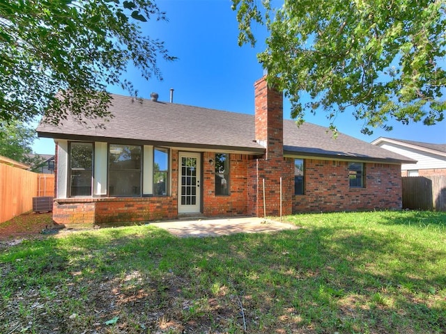1033 Linn Ln, Yukon, OK 73099 - back of property with brick siding, a chimney, a patio, and a shingled roof