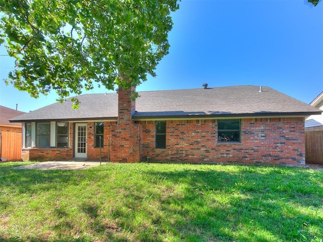 1033 Linn Ln, Yukon, OK 73099 - rear view of property with brick siding, a patio area, and a shingled roof