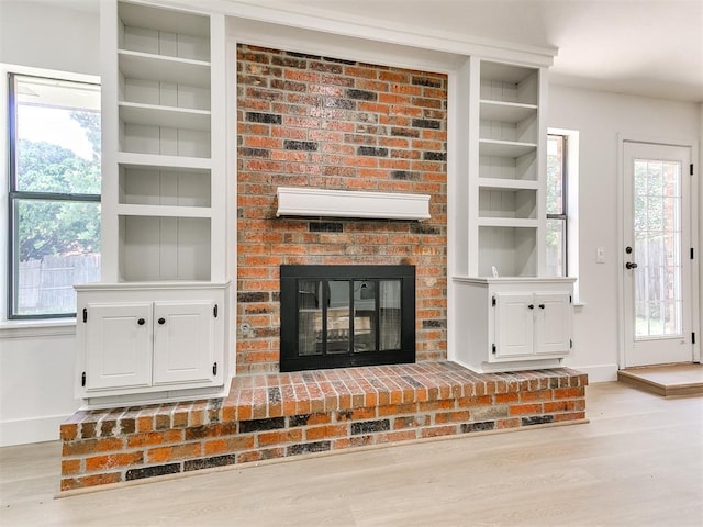 1033 Linn Ln, Yukon, OK 73099 - unfurnished living room featuring wood finished floors, baseboards, and built in features