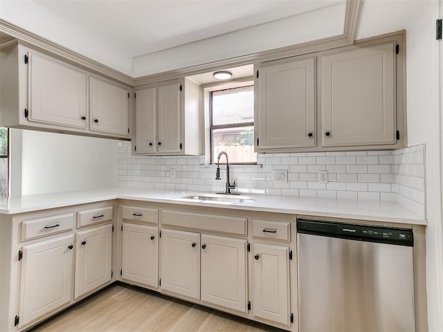 1033 Linn Ln, Yukon, OK 73099 - kitchen with stainless steel dishwasher, a sink, light countertops, and decorative backsplash