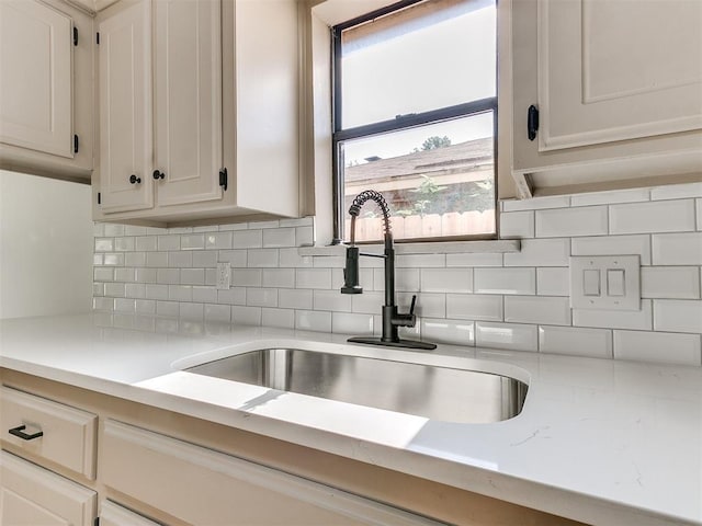 1033 Linn Ln, Yukon, OK 73099 - kitchen featuring a sink, light countertops, tasteful backsplash, and white cabinets