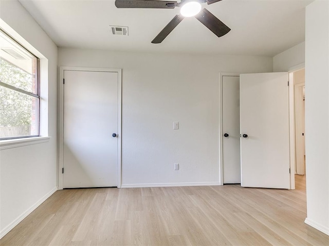 1033 Linn Ln, Yukon, OK 73099 - unfurnished bedroom with light wood-style floors, baseboards, and a ceiling fan