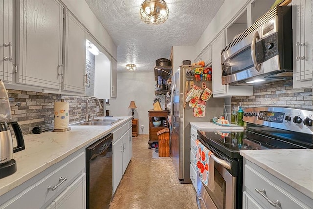 1301 Canterbury Blvd, Altus, OK 73521 - kitchen featuring appliances with stainless steel finishes, a sink, decorative backsplash, and a textured ceiling