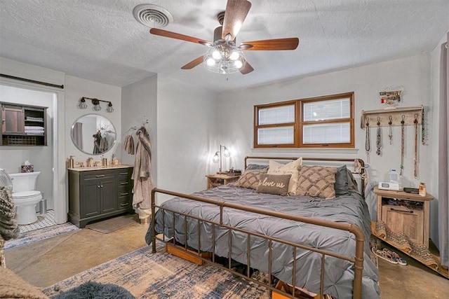 1301 Canterbury Blvd, Altus, OK 73521 - bedroom featuring a textured ceiling, ceiling fan, and ensuite bathroom