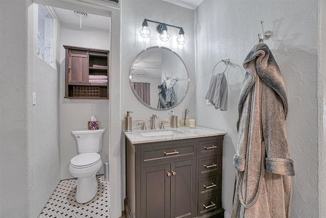 1301 Canterbury Blvd, Altus, OK 73521 - bathroom featuring vanity, toilet, a textured wall, and tile patterned flooring