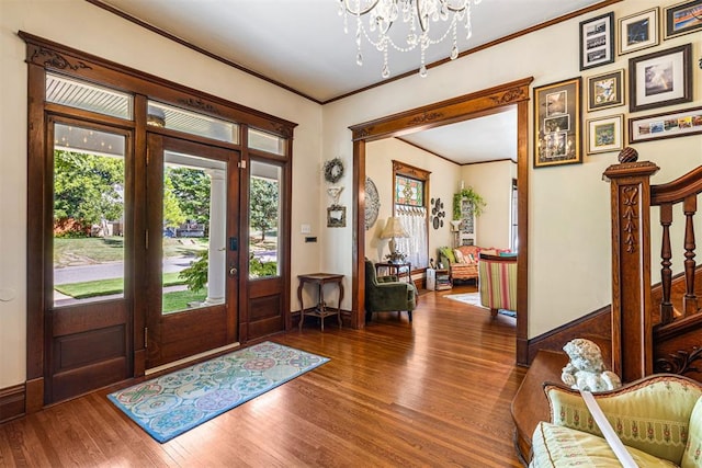 516 S Macomb Ave, El Reno, OK 73036 - entrance foyer featuring a chandelier, wood finished floors, ornamental molding, baseboards, and stairway