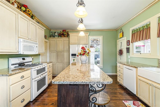 516 S Macomb Ave, El Reno, OK 73036 - kitchen featuring white appliances, ornamental molding, cream cabinetry, dark wood-style flooring, and a kitchen island