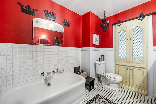 516 S Macomb Ave, El Reno, OK 73036 - full bathroom with wainscoting, a bath, and toilet