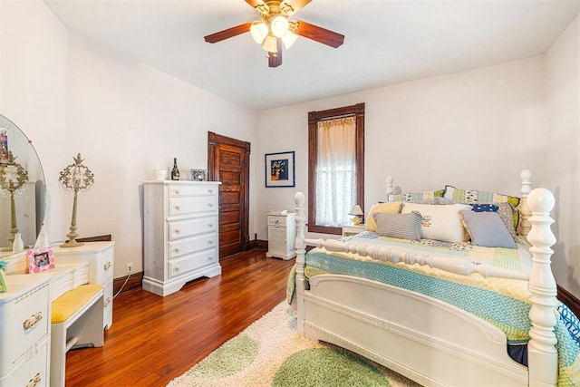 516 S Macomb Ave, El Reno, OK 73036 - bedroom featuring wood finished floors, baseboards, and a ceiling fan