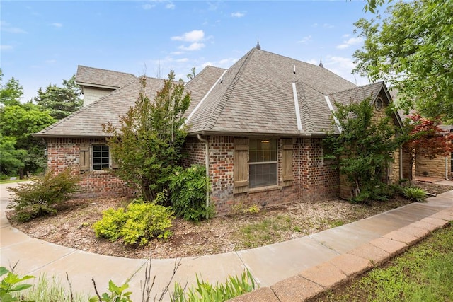 6373 Stone Valley Dr, Edmond, OK 73034 - view of side of property with brick siding and a shingled roof