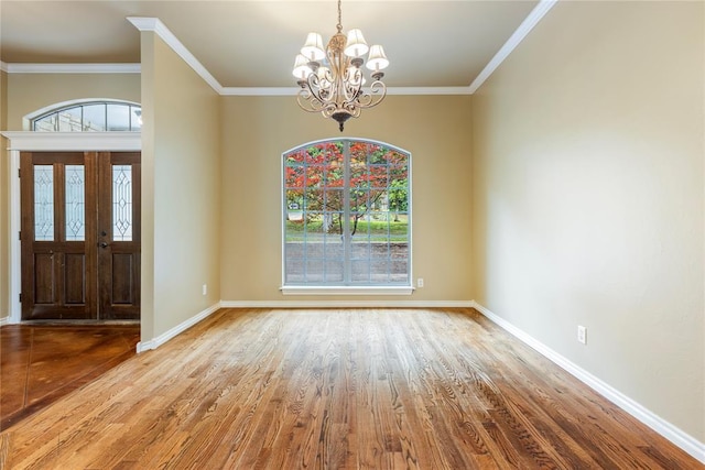 6373 Stone Valley Dr, Edmond, OK 73034 - entryway with a chandelier, wood finished floors, baseboards, and ornamental molding