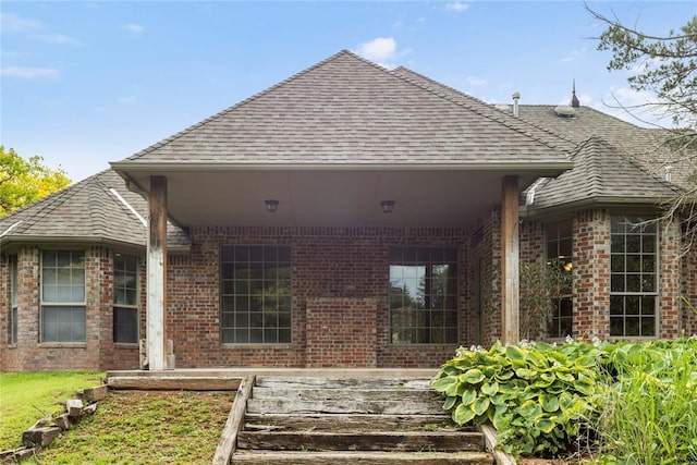 6373 Stone Valley Dr, Edmond, OK 73034 - rear view of property with brick siding and a shingled roof