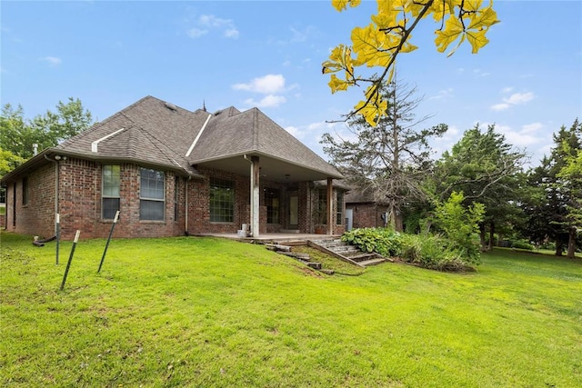 6373 Stone Valley Dr, Edmond, OK 73034 - back of house featuring brick siding, a yard, and a patio