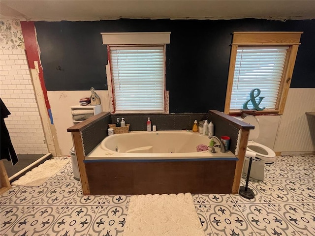 513 E Monroe St, Maud, OK 74854 - bathroom with toilet, a tub with jets, tile patterned flooring, and a shower