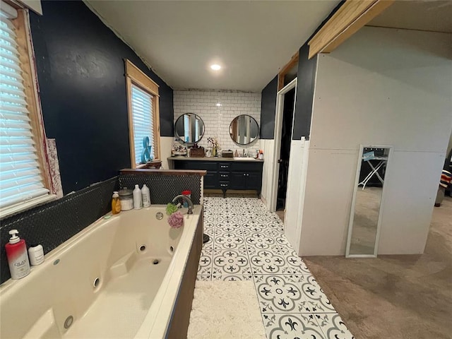 513 E Monroe St, Maud, OK 74854 - full bath featuring vanity, a jetted tub, and tasteful backsplash