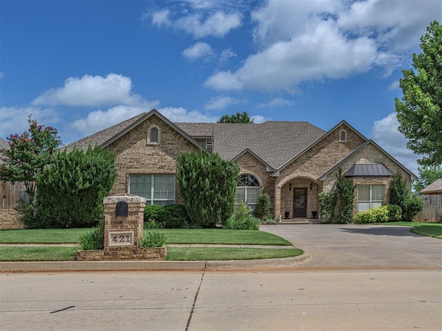 421 Meadow Run Ct, Yukon, OK 73099 - view of front of home featuring brick siding, stone siding, concrete driveway, and roof with shingles