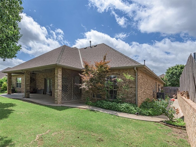 421 Meadow Run Ct, Yukon, OK 73099 - rear view of house featuring brick siding, a patio, central air condition unit, and roof with shingles