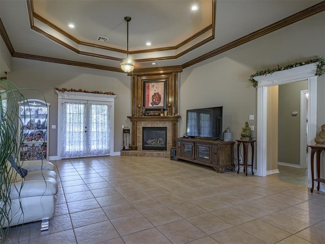 421 Meadow Run Ct, Yukon, OK 73099 - living room featuring a raised ceiling, light tile patterned floors, crown molding, baseboards, and a tile fireplace
