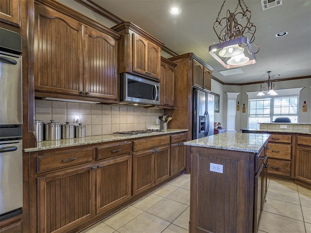 421 Meadow Run Ct, Yukon, OK 73099 - kitchen featuring stainless steel appliances, crown molding, backsplash, light tile patterned flooring, and arched walkways