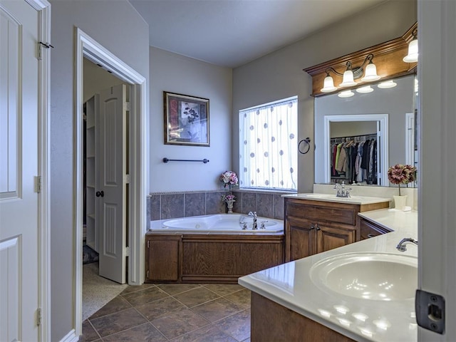421 Meadow Run Ct, Yukon, OK 73099 - bathroom with vanity, a garden tub, and a spacious closet