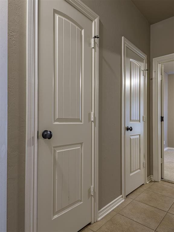 421 Meadow Run Ct, Yukon, OK 73099 - hallway featuring light tile patterned floors and baseboards