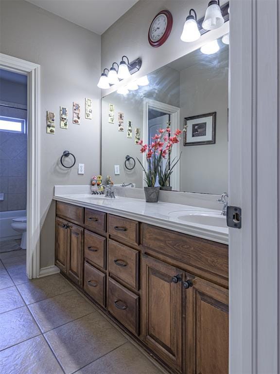 421 Meadow Run Ct, Yukon, OK 73099 - bathroom featuring double vanity, tile patterned flooring, toilet, and baseboards