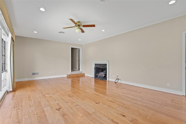 1616 SW 6th Ave, Ardmore, OK 73401 - unfurnished living room featuring a ceiling fan, baseboards, light wood finished floors, a fireplace, and recessed lighting